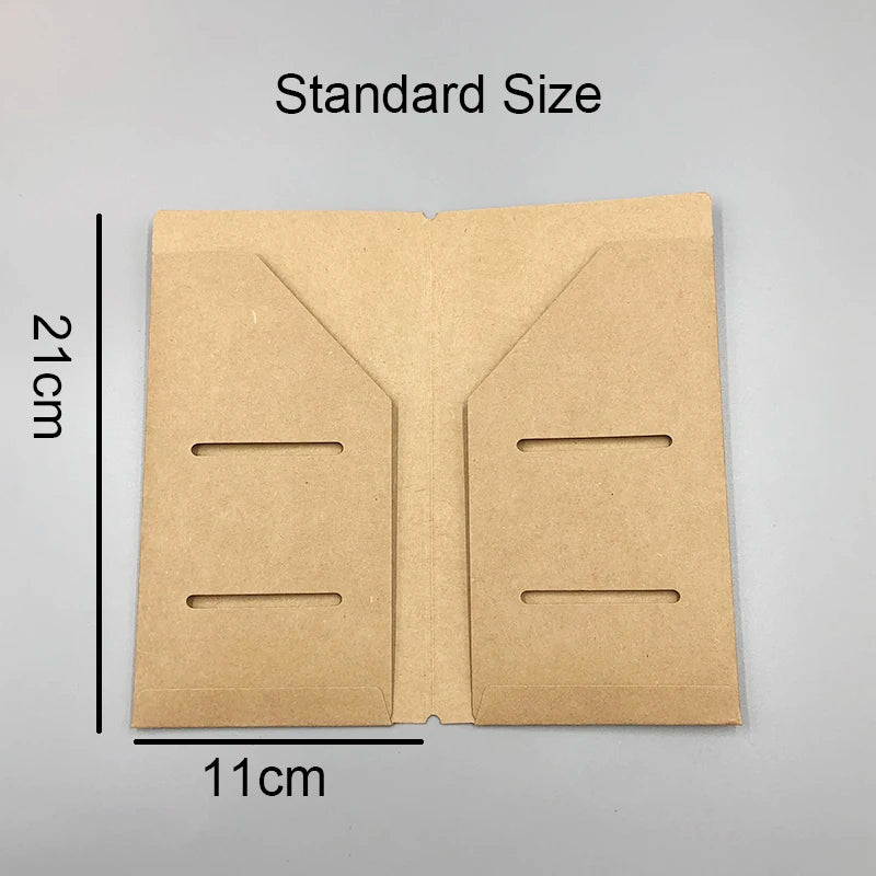 A tan, folded notebook shell with two horizontal slots is shown next to a measurement scale.