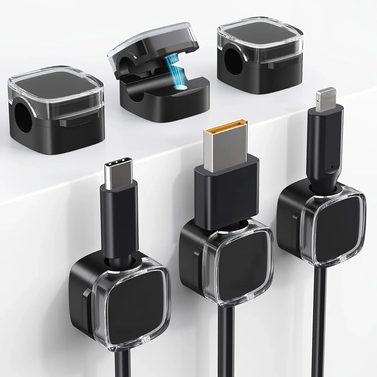 A set of black magnetic cable management clips for organizing wires on desks and walls.