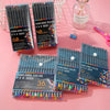 A collection of fine line marker pens in various colors and quantities displayed on a pink background.