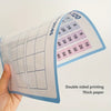 A hand holds a double-sided printed thick paper math poster showing a 120-point number line grid.