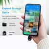 A hand holds a smartphone displaying storage management features, next to a USB-C to SD/TF card reader with a keychain.