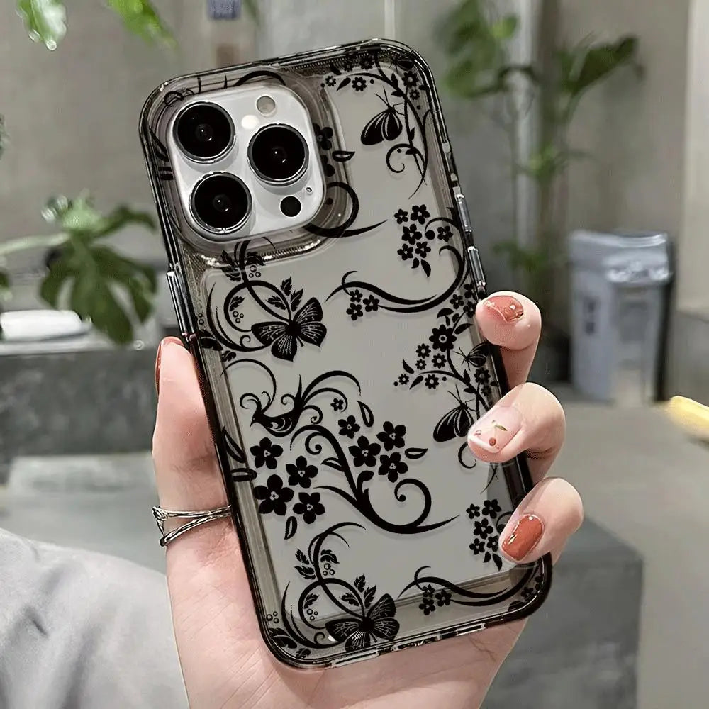 A hand holds a clear phone case with a black floral pattern and multiple camera lenses.