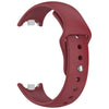 A close-up view of a red silicone replacement strap for a Mi Band watch, showing the buckle and strap design.