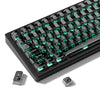 A close-up view of a black mechanical keyboard with crystal clear RGB keycaps and included switches.