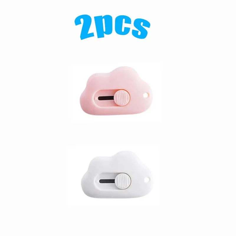 A set of two pink and white utility knives shaped like rabbit clouds.