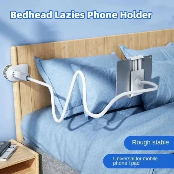 A white flexible gooseneck phone holder is mounted on a wooden bedhead for mobile phone or iPad use.