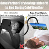 A woman is using a 360° rotating tablet and phone stand to view content while lying in bed during cold weather.