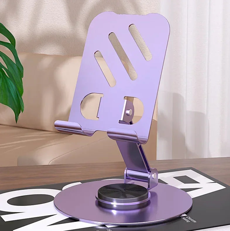 A purple 360-degree rotating mobile phone holder mounted on a flat base for hands-free viewing.