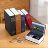 A stack of The New English Dictionary books next to an open mini dictionary safe containing keys and valuables.