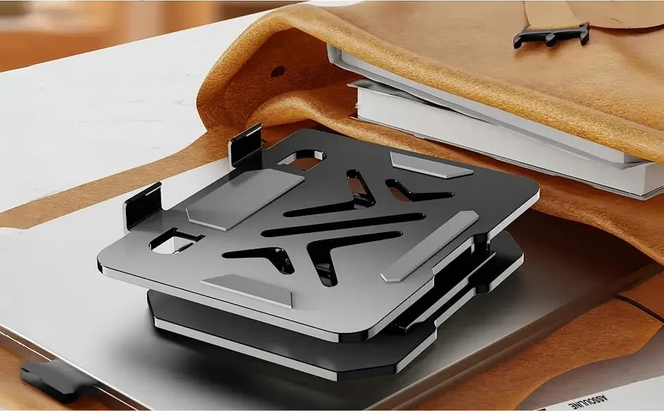 A silver adjustable dual rod tablet and phone stand is shown resting on a brown leather-bound notebook.
