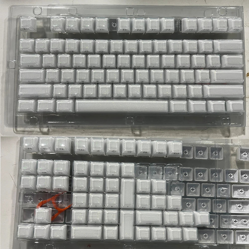 A set of translucent pink jelly keycaps for mechanical keyboards displayed in a plastic case.