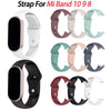 A collection of silicone replacement straps for a Mi Band watch in various colors and styles.
