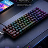 A close-up view of a black compact mechanical keyboard with RGB backlight and premium keycaps on a dark surface.