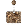 A leopard print retractable badge holder with a round charm attached.