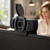 Black privacy lens cover for a webcam mounted on a monitor.