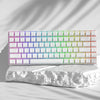 A close-up of a rectangular array of custom printed jelly keycaps in a rainbow gradient on a white surface.