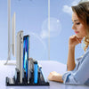 A woman is using a black 3-slot vertical laptop stand organizer on a white desk.