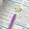 A close-up of a purple gel pen writing on a sheet of paper with English and Chinese text, featuring a Mark Key Point diagram.