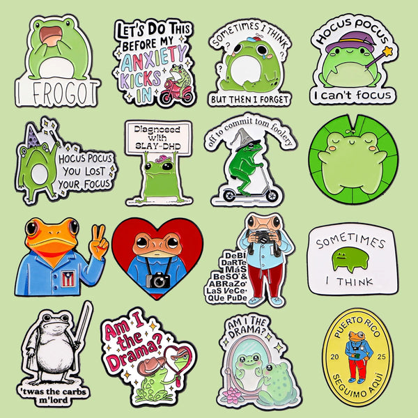 A collection of enamel pins featuring various frogs and humorous text