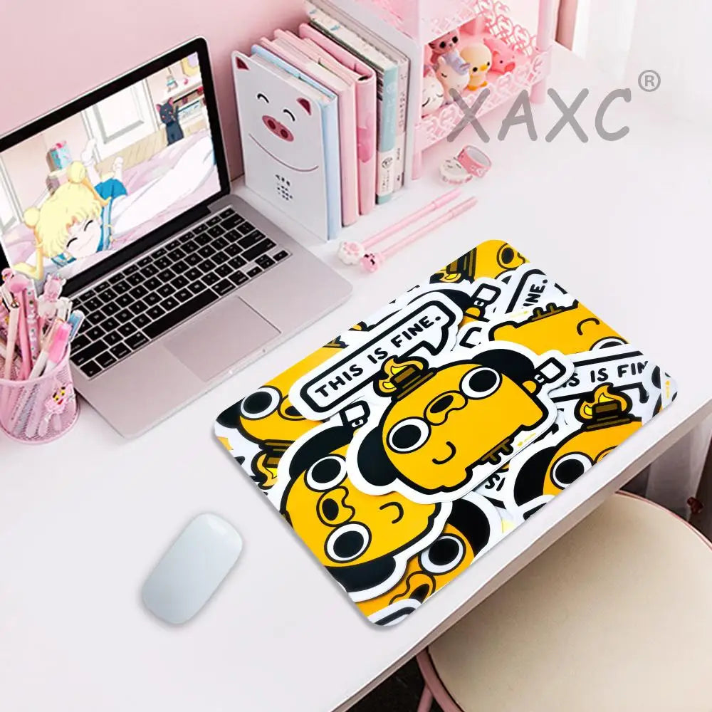 A yellow and black dog face gaming mouse pad with the text This Is Fine