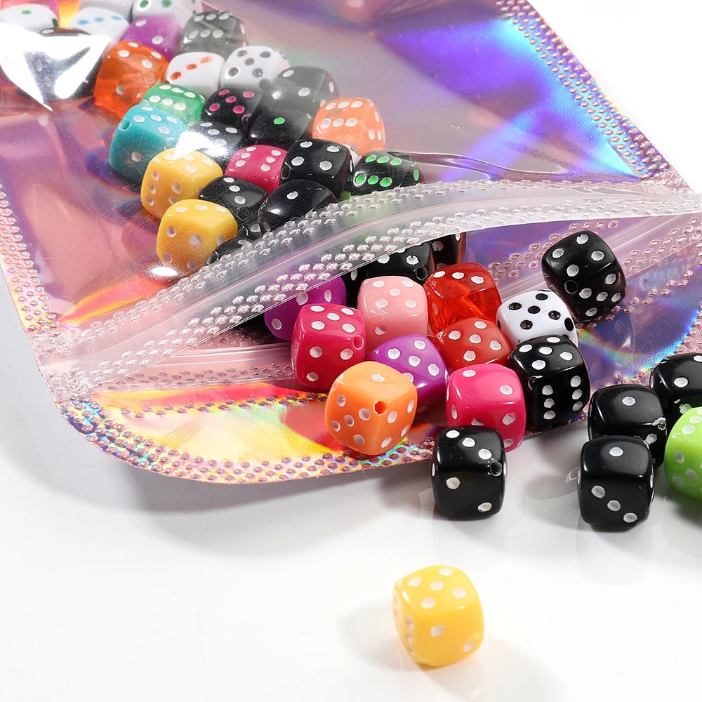 A collection of iridescent self-sealing jewelry pouches in various colors and shapes displayed on a translucent background.