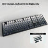 A black mechanical keyboard featuring PBT keycaps, with additional keycaps shown separately.