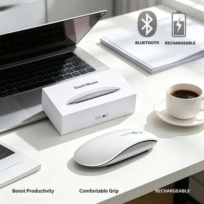 A white rechargeable wireless Bluetooth mouse is shown next to a laptop and a cup on a desk.