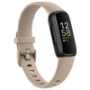 A beige silicone replacement strap for a Fitbit Inspire series watch with a black display showing 12:58 and a heart rate of 7