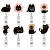 A set of four black cat-themed retractable ID badge holders with crocodile clips and pink accents.