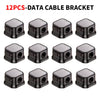Twelve black plastic data cable brackets or clips arranged in a grid.