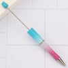 A set of DIY beadable pens with a silver needle and colored tips in blue, pink, and white.