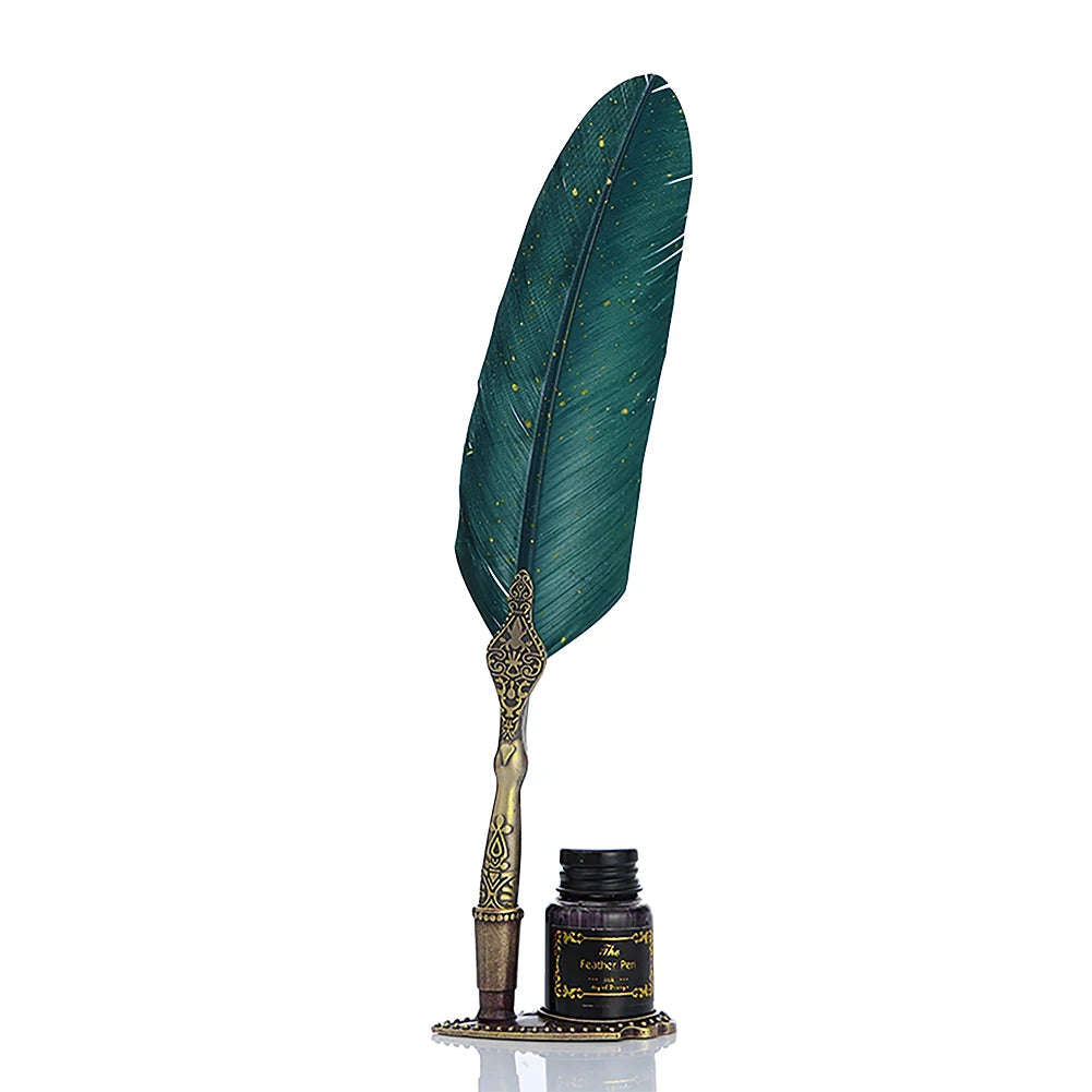 A feather dip pen set featuring a dark teal feather and gold calligraphy nib displayed on a small box.