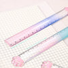 A pink gradient measuring ruler is shown next to a cat paw on a white grid paper, demonstrating a clear and flat line.