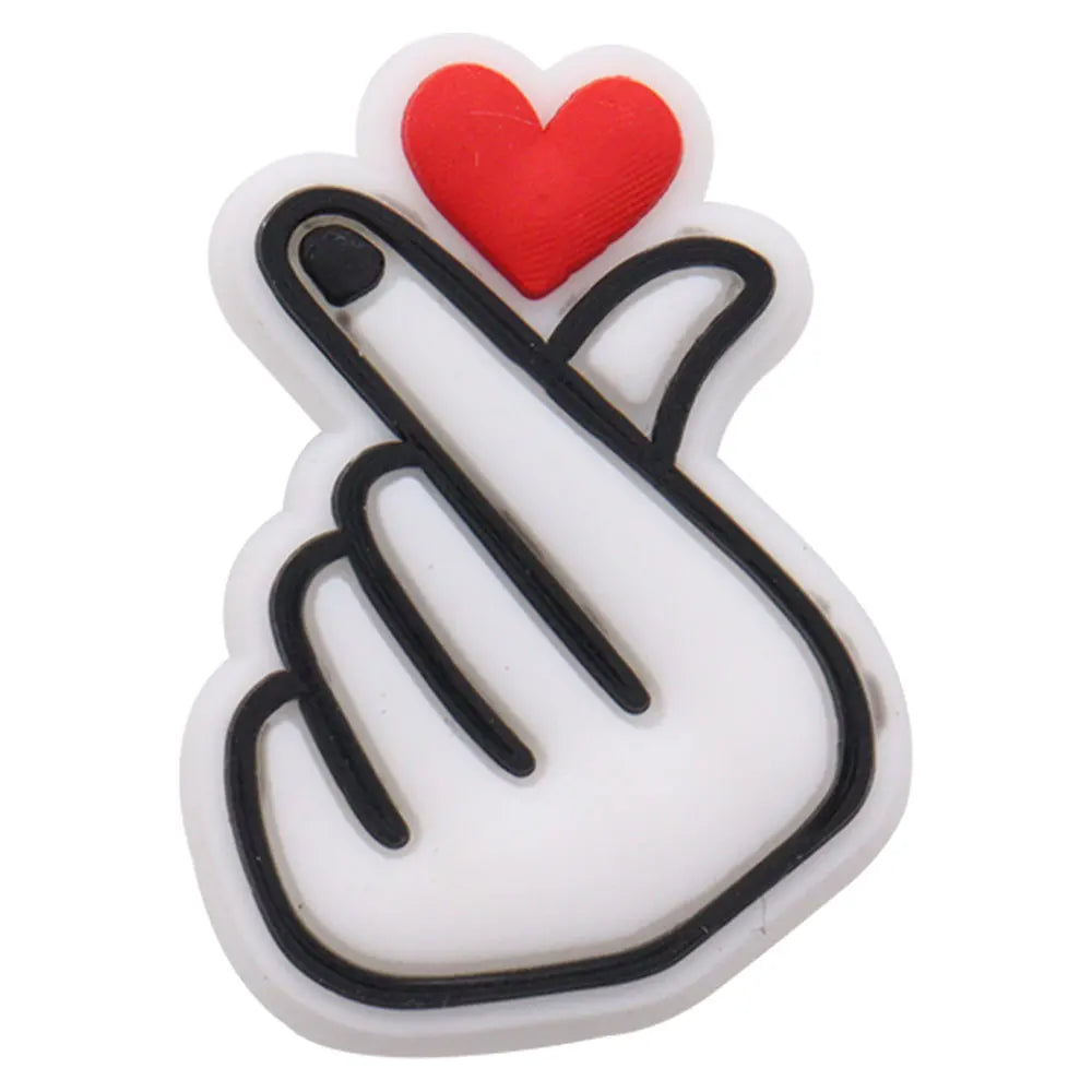A white charm featuring a red heart and a black hand gesture sign.