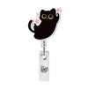 A black cat charm attached to a silver retractable ID badge holder with a crocodile clip.