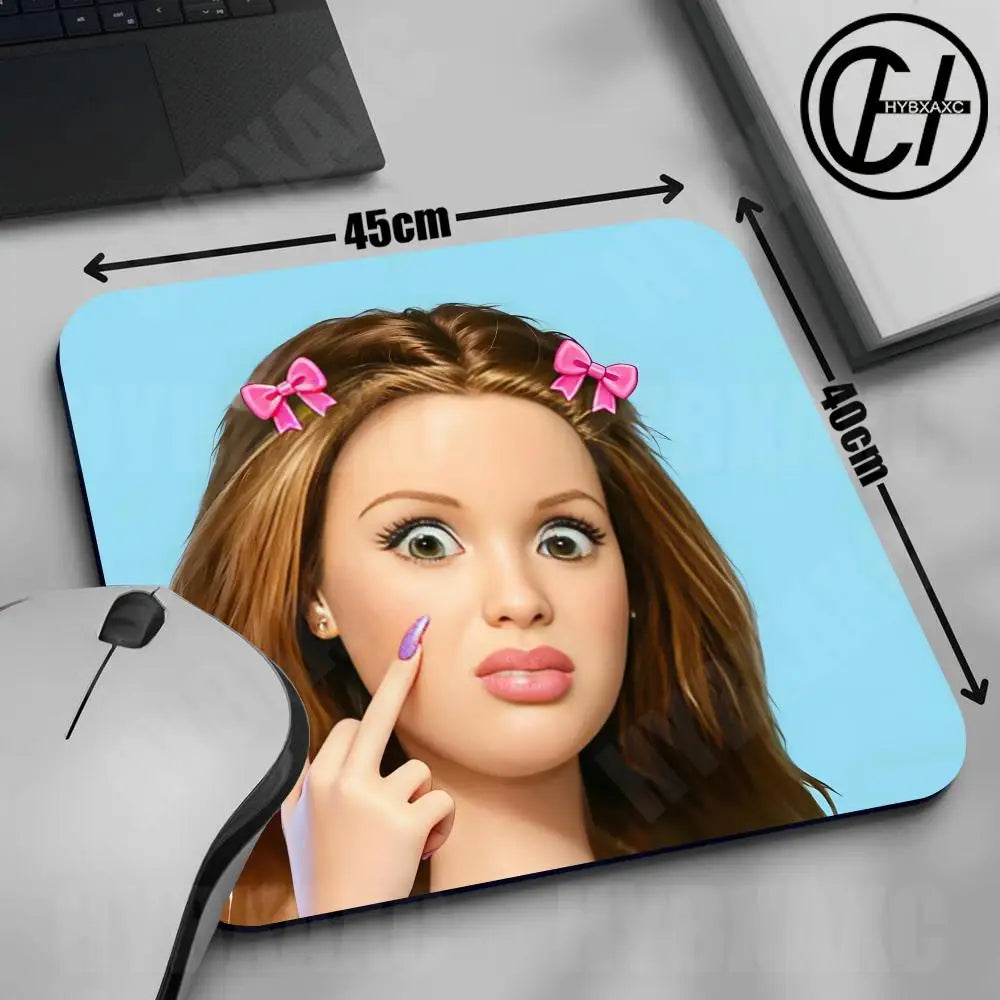 A close-up of a cute doll face design on a mouse pad with measurements and a computer mouse visible.