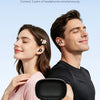 A couple listening to music together while holding a black wireless clip-on earbud charging case.