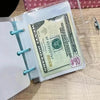 A clear plastic binder holds a US $40 bill and a white sheet of paper.