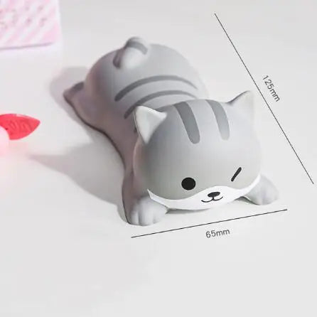 A gray, cat-shaped ergonomic wrist rest for a mouse or keyboard, shown from above.