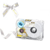 A clear label maker device with a ribbon and a bow, used for creating custom stickers.