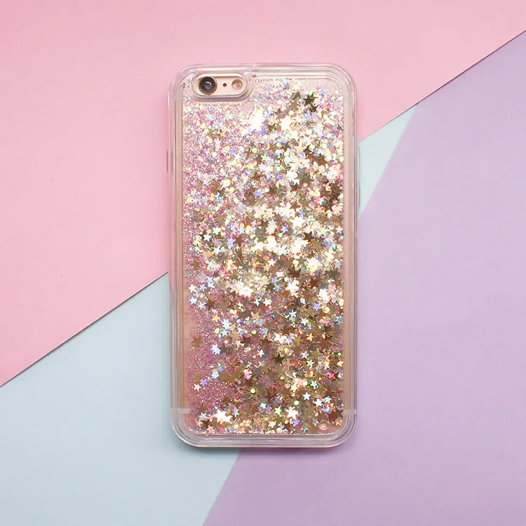Clear phone case filled with pink and gold glitter stars and hearts against a pastel background.
