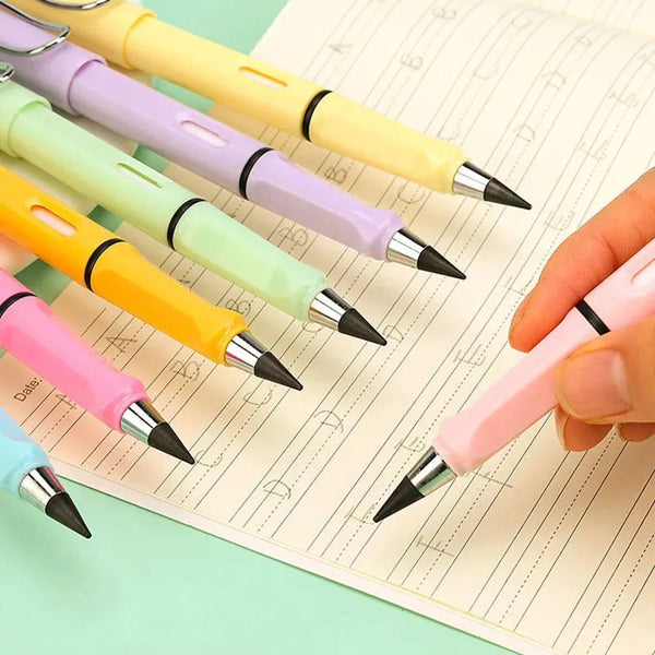 A hand holds a pink pen writing on lined paper, surrounded by several colorful pencils.