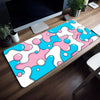 A colorful, abstract blue and pink liquid design mouse pad placed on a wooden desk.