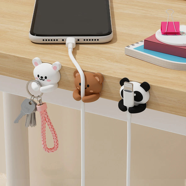 Organizadores de cables de escritorio de caricatura con soportes en forma de animal para gestionar cables en una superficie d