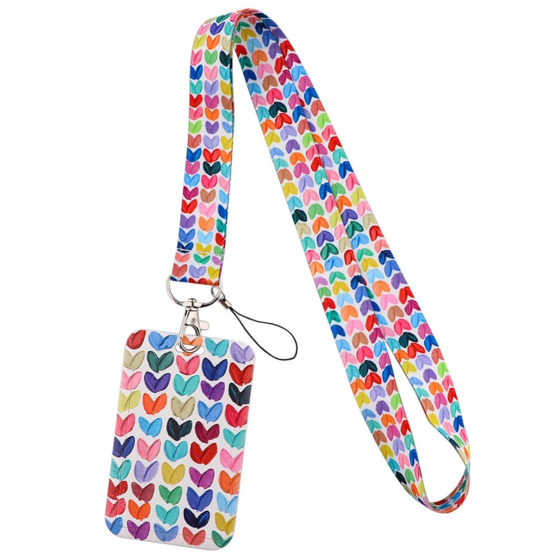 A colorful, patterned fabric lanyard with a metal clip for holding ID badges and accessories.