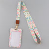 A pink floral patterned lanyard with a rectangular ID badge holder attached to a brown leather clip.
