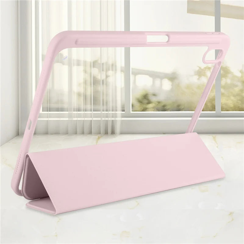 A pink protective case for an Apple iPad is shown resting on a white surface in front of a window.
