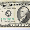 A close-up of a historical United States ten dollar banknote featuring George Washington.
