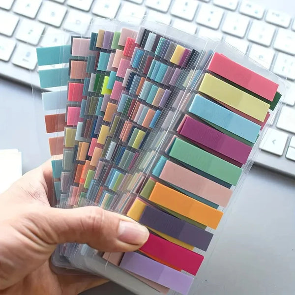 A hand holds a clear plastic pack of 200 colorful fluorescent transparent tabs for organization.