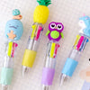 Four cute cartoon mini ballpoint pens featuring a pineapple, owl, and unicorn design on a grid background.